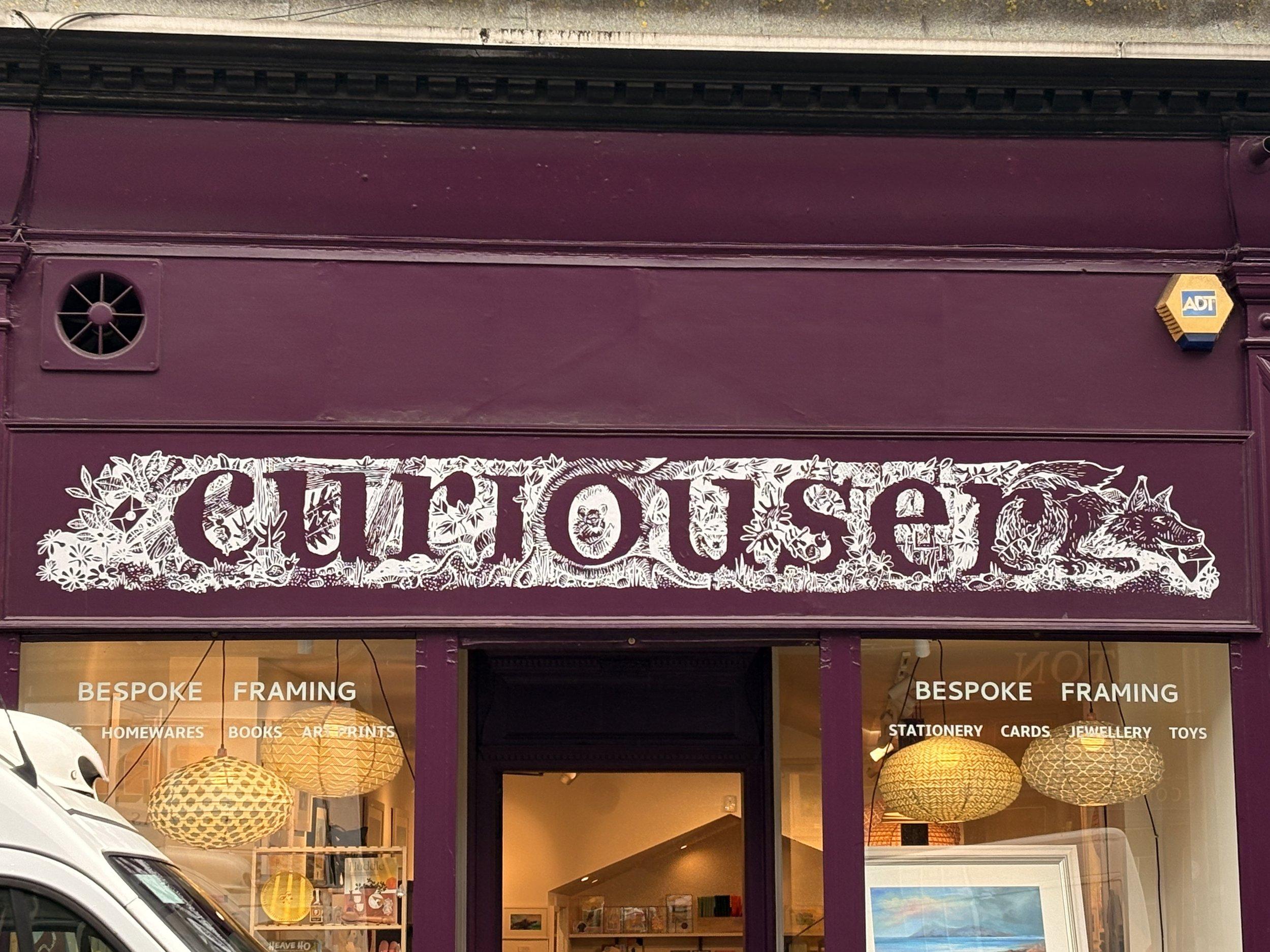 Hand-painted shop sign on an Edinburgh storefront