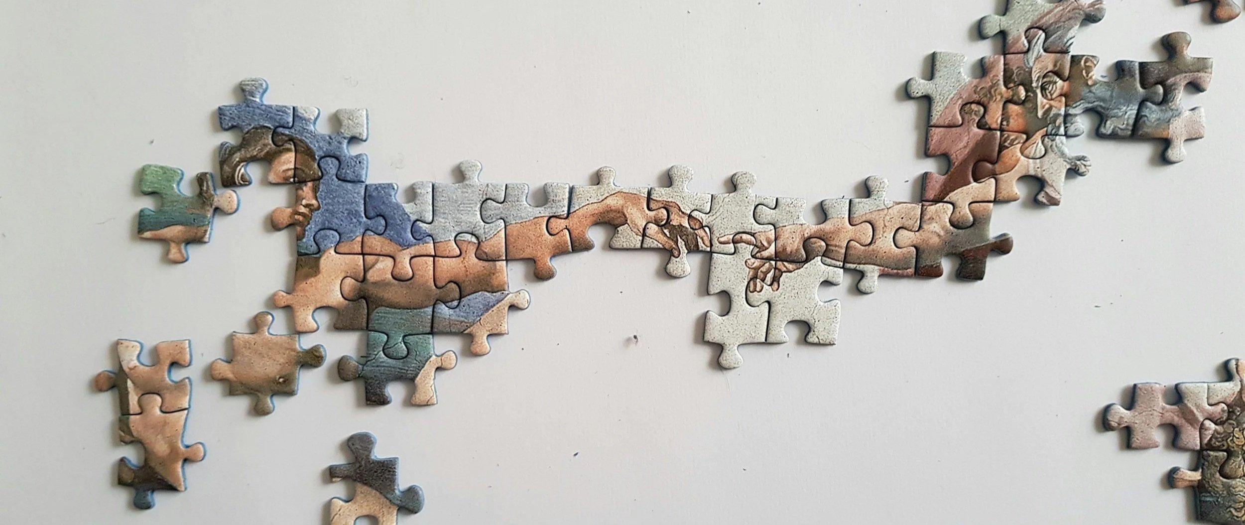 Scattered puzzle pieces on a table